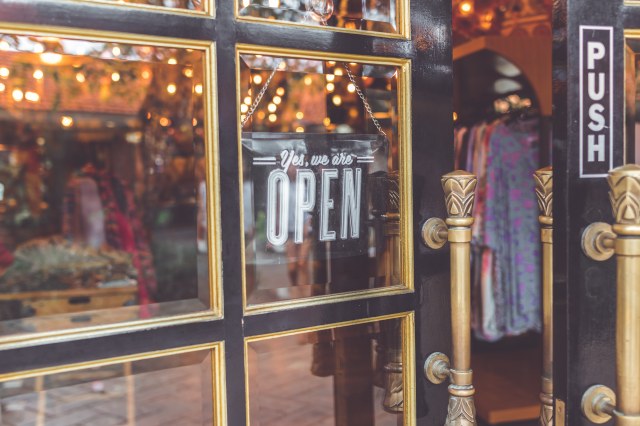 Front door to store with an open sign